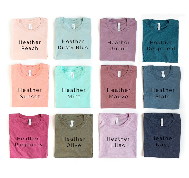 May include: Twelve folded t-shirts in various heather colors, including peach, dusty blue, orchid, deep teal, sunset, mint, mauve, slate, raspberry, olive, lilac, and navy.