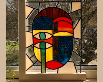 Modern stained glass window, art, interior, mask “tearing eyes”