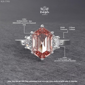 May include: A silver ring featuring a large, hexagonal, pink lab-grown diamond, flanked by two smaller, pear-shaped diamonds. The ring's width is 1.90mm and thickness is 1.60mm. The ring is from Rubysta Jewels.