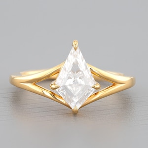 May include: A gold ring with a large, clear, kite-shaped diamond.