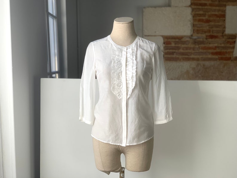 white silk blouse with a frill