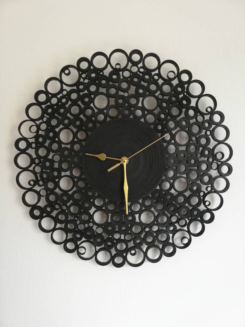 orologio da parete creato con cartoncini neri.il diametro è di 38 cm e le lancette sono dorate