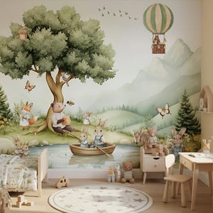 May include: A whimsical nursery scene featuring a mural of a forest with animals, including a bear, fox, and rabbits. A hot air balloon floats above the mountains. The room includes a bed, table, and rug.