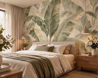 May include: A bedroom featuring a large wall mural of oversized green and beige banana leaves behind a bed with white linens, a textured olive green throw blanket, and a matching bolster pillow, flanked by two wooden nightstands with pendant lights.