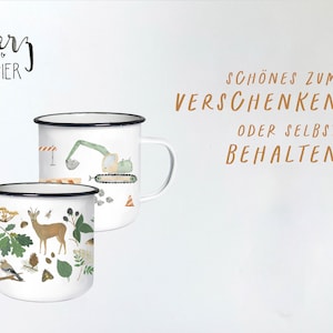 May include: Two white enamel mugs with black rims. One mug features a green excavator with a brown tree stump and a blue bird. The other mug features a brown deer, a blue bird, and green leaves. The text "herz papier" is in black lettering on a white background. The text "SCH&Ouml;NES ZUM VERSCHENKEN ODER SELBST BEHALTEN" is in brown lettering on a white background.