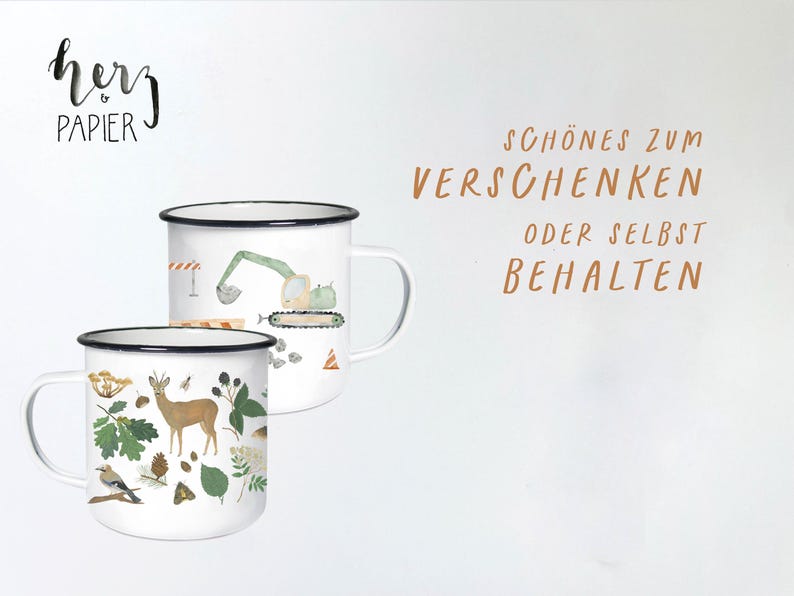 May include: Two white enamel mugs with black rims. One mug features a green excavator with a brown tree stump and a blue bird. The other mug features a brown deer, a blue bird, and green leaves. The text "herz papier" is in black lettering on a white background. The text "SCH&Ouml;NES ZUM VERSCHENKEN ODER SELBST BEHALTEN" is in brown lettering on a white background.