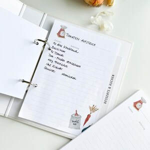 May include: A white binder with a recipe page for tomato spread. The page has a handwritten list of ingredients and instructions. The page is decorated with a watercolour illustration of a scale and a bag of flour.
