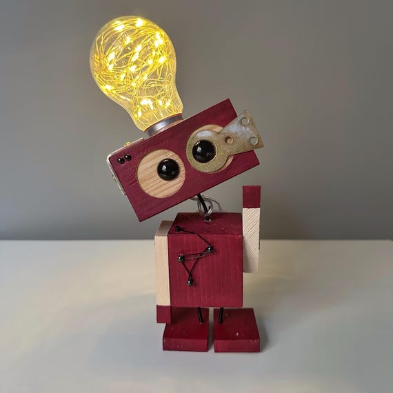 A hand-assembled steampunk robot desk lamp that doubles as kinetic sculpture — actually looks like someone built it in a workshop.