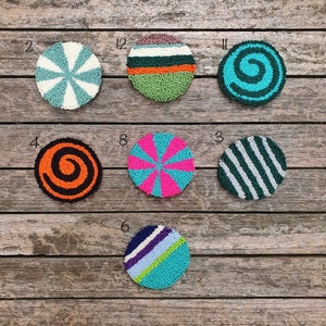 May include: Nine colorful round rug designs with different patterns, including stripes, swirls, and sunbursts. The rugs are numbered 2, 4, 8, 12, 11, 3, and 6.