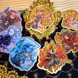 Może przedstawiać: Zestaw dziesięciu kolorowych naklejek z różnymi postaciami. Naklejki są wydrukowane na błyszczącym materiale winylowym i idealnie nadają się do dodania odrobiny fantazji do laptopów, butelek z wodą, dzienników i nie tylko.