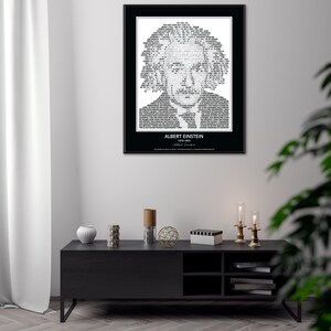 May include: A black and white typography art print featuring a portrait of Albert Einstein. The portrait is made up of words and text. The print is framed in a black frame and is hanging on a white wall. The print is above a black TV stand with a white vase, a wooden decorative object, and a black and white striped box.
