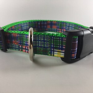 May include: A green, blue, red, and yellow plaid dog collar with a black plastic buckle.