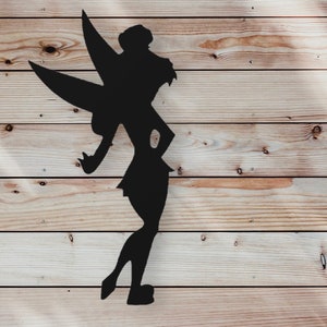 May include: Black silhouette of a fairy with wings outstretched, standing on a woodgrain background.