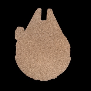 Puede incluir: Una silueta dorada con purpurina del Millennium Falcon, la nave espacial de Star Wars.