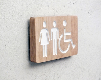 Bathroom wooden door sign with engraved male / female and handicap pictograms. Mixt and disabled restroom sign. Wooden unisex bathroom sign