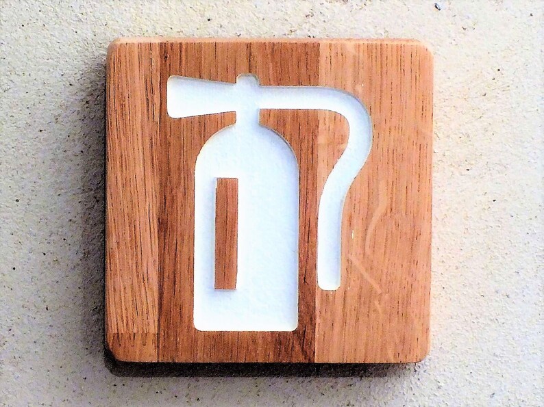 May include: A white fire extinguisher symbol carved into a wooden plaque.
