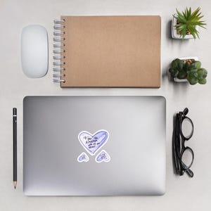 May include: A set of stickers featuring a heart design with the handwritten text "Fight the Algorithm with all your heart". The stickers are light purple with a white border. Ideal for laptops or notebooks.