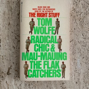 May include: A book cover with a white background and green text. The title is "Radical Chic & Mau-Mauing the Flak Catchers" by Tom Wolfe. The book is by the author of "The Right Stuff".