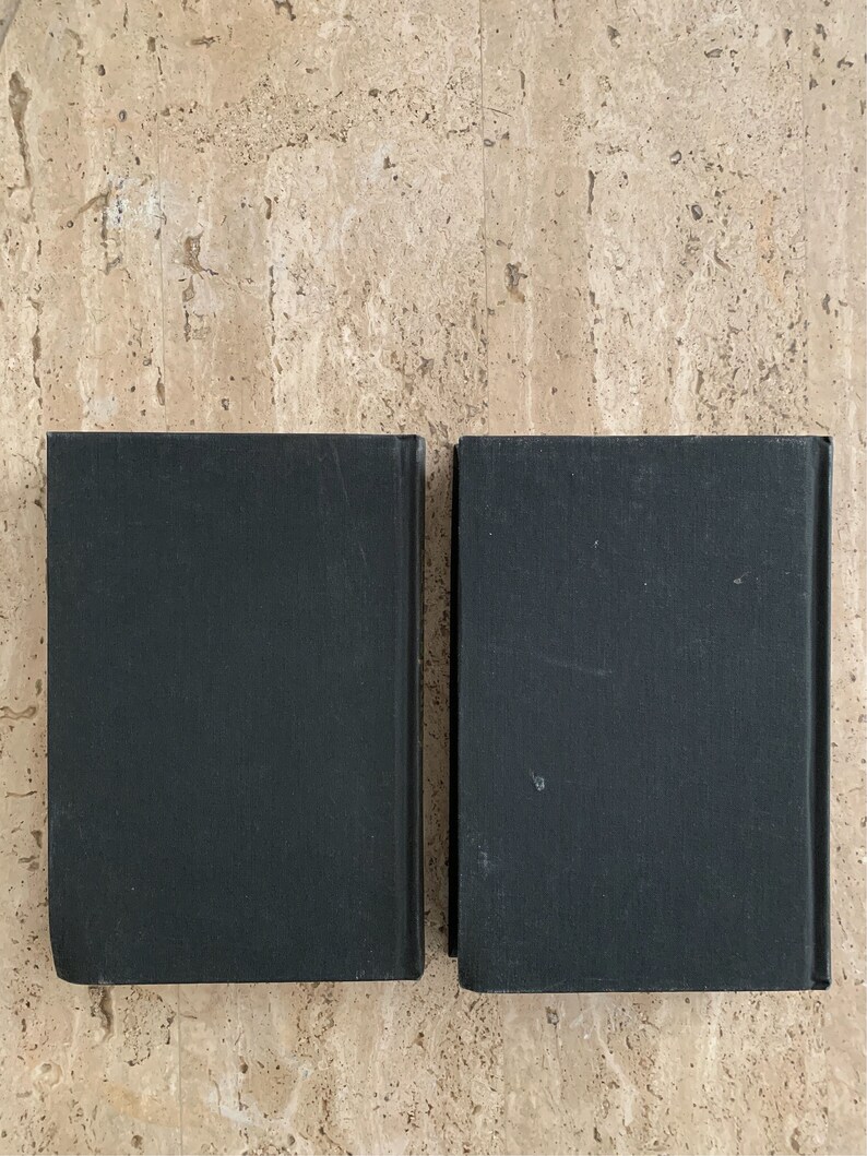 May include: Two black hardcover books with plain covers.