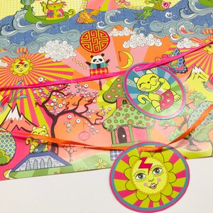 May include: A pink and yellow wrapping paper with a whimsical design featuring a cat, a panda, a sun, and a mushroom house. The paper is decorated with ribbons and stars.
