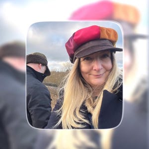 May include: A multi-colored newsboy cap featuring panels in shades of red, burgundy, and orange, complemented by a dark brown brim. The cap is constructed with a structured crown and a short, stiff visor, showcasing a vibrant patchwork design.
