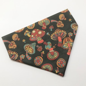 May include: A dark green bandana with a colorful mushroom pattern. The mushrooms are in various shades of red, orange, yellow, and green.