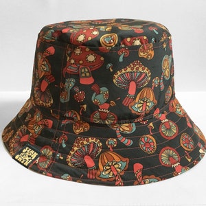 Shroom loves a bucket hat. So mush love for these. A best selling fisherman style hat handmade from a magic mushrooms, toadstools and fungi textile design. Reversible hats with a denim reverse.