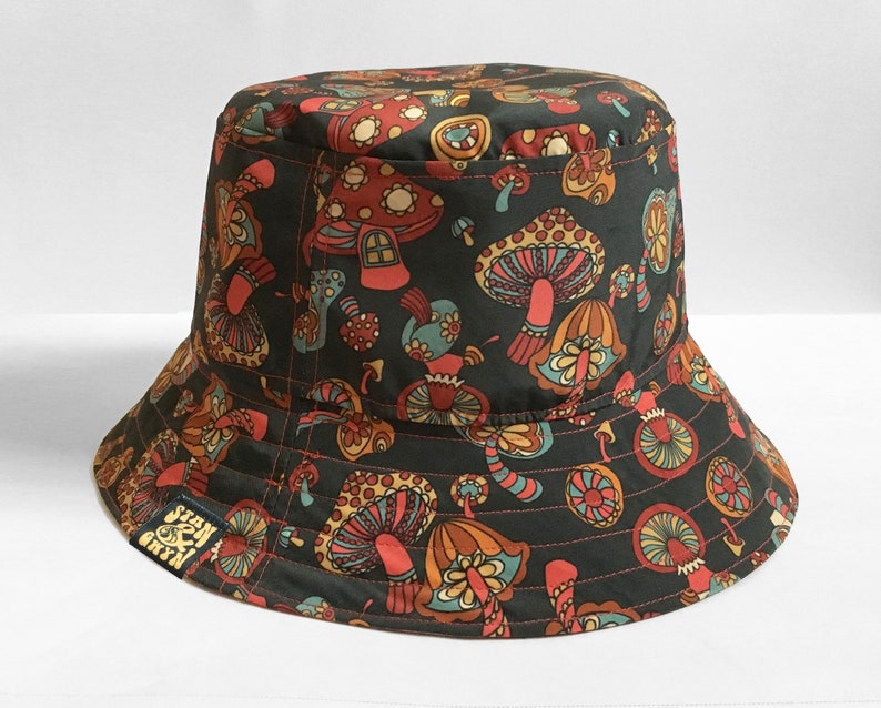 Shroom loves a bucket hat. So mush love for these. A best selling fisherman style hat handmade from a magic mushrooms, toadstools and fungi textile design. Reversible hats with a denim reverse.