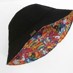 May include: A black bucket hat with a colorful psychedelic print on the inside. The print features rainbows, mushrooms, clouds, and other whimsical designs.