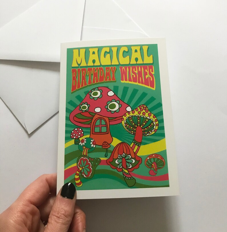 Op de afbeelding: Een kaart met een psychedelisch ontwerp met paddenstoelen en de tekst "Magical Birthday Wishes".