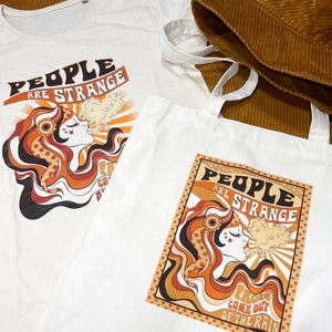 May include: Two white cotton tote bags with a retro 1960s style graphic design featuring a woman with long hair and the text "People are strange, Faces come out of the rain".