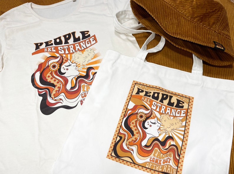 May include: Two white cotton tote bags with a retro 1960s style graphic design featuring a woman with long hair and the text "People are strange, Faces come out of the rain".