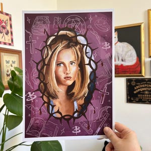 May include: A purple background with a white outline of a crown of thorns, a pentagram, a cross, a book, a stake, and other symbols. In the centre of the crown of thorns is a portrait of a woman with blonde hair.