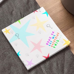 May include: A white card with a colorful star pattern and the text "HANG ON. LET ME OVERTHINK THIS..." printed on it.