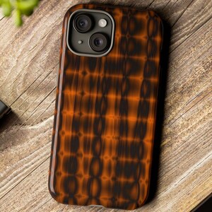 May include: A brown and black phone case with a geometric pattern. The case has a raised camera bump with two lenses.