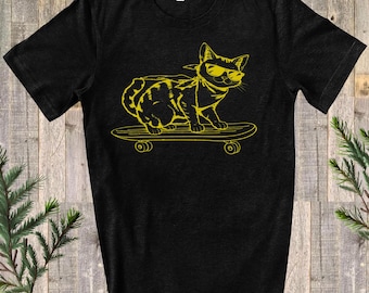 May include: A black t-shirt with a yellow graphic of a cat wearing sunglasses and riding a skateboard.