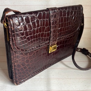 May include: A wooden sign with the words "Welcome to our home" in a handwritten font. The sign has a distressed finish, creating a rustic aesthetic, and is designed for a front door or hallway.