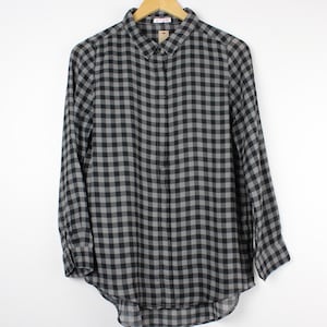 May include: A black and gray plaid long-sleeved button-down shirt.