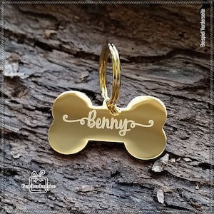Puede incluir: Chapa para perro de hueso de oro con el nombre "Benny" grabado. La chapa tiene un anillo para sujetarla a un collar.
