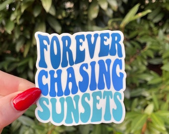 May include: A white sticker with blue and teal text that reads "FOREVER CHASING SUNSETS".