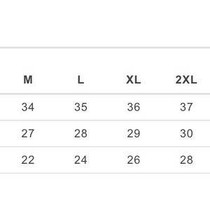 May include: Size chart showing measurements in inches for a shirt in sizes S through 5XL. Measurements include sleeve length, full body length, and body width.