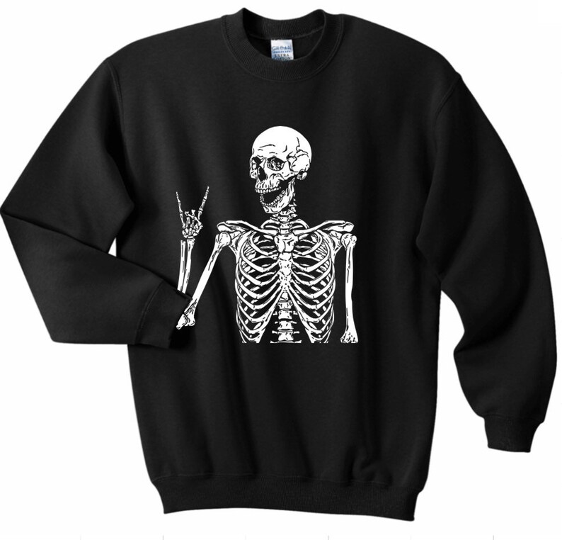 May include: Black sweatshirt with a white skeleton graphic. The skeleton is making a peace sign with one hand and has a smiling face.