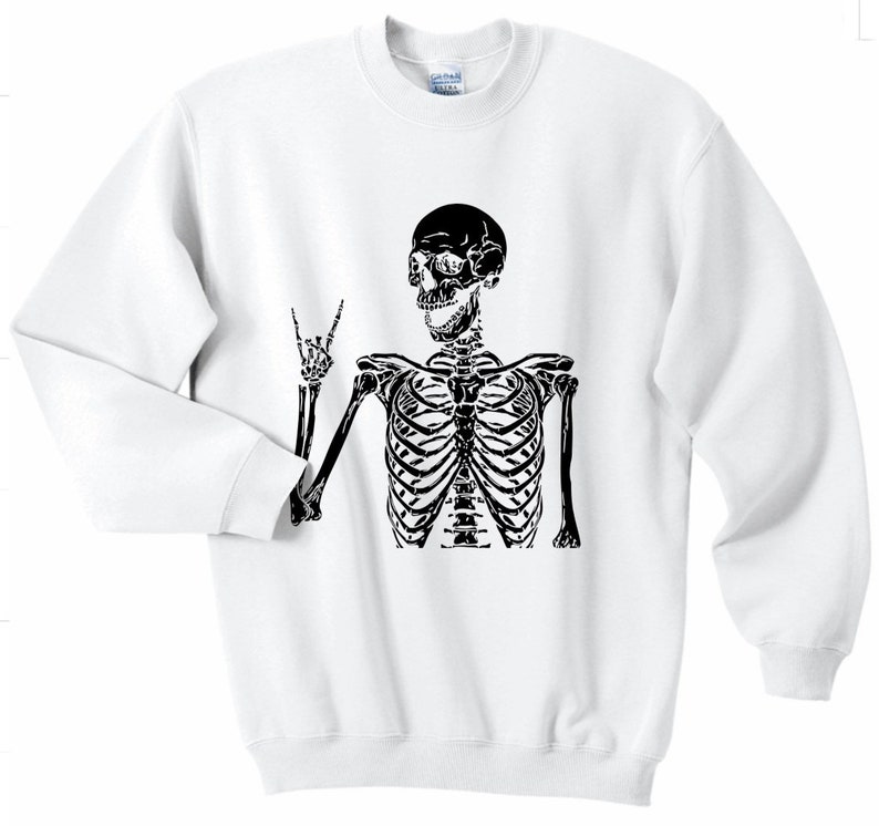 May include: White sweatshirt with a black skeleton graphic wearing a peace sign. The skeleton is smiling.