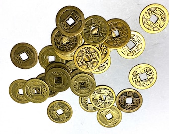 May include: A collection of 17 gold-colored Chinese coins with a square hole in the center. Each coin has Chinese characters and symbols on the front and back.