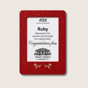 Peut inclure: Un cadre rectangulaire à paillettes rouges entourant une plaque blanche avec le texte noir 40th Anniversary, Ruby, Represents the passion and strength of a relationship, Congratulations from, et Front Porch Homes avec une illustration.