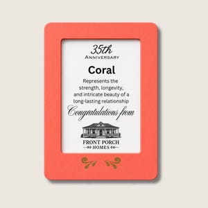 Puede incluir: Un marco rectangular de color coral que contiene una tarjeta blanca con el texto en negro 35th Anniversary, Coral, Represents the strength, longevity, and intricate beauty of a long-lasting relationship, Congratulations from, y Front Porch Homes.