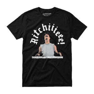 May include: Black t-shirt with a graphic of a man looking upwards, with the word "Ritchiiiee!" in a white, arched font above him. The shirt has a crew neck and short sleeves.