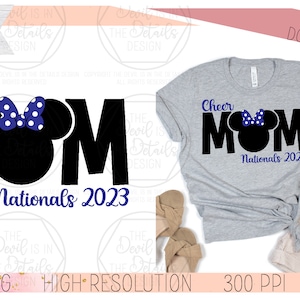 May include: Black and white graphic design of the word "MOM" with a blue bow and ears on the "O". The text "Cheer" is above the word "MOM" and the text "Nationals 2023" is below the word "MOM".