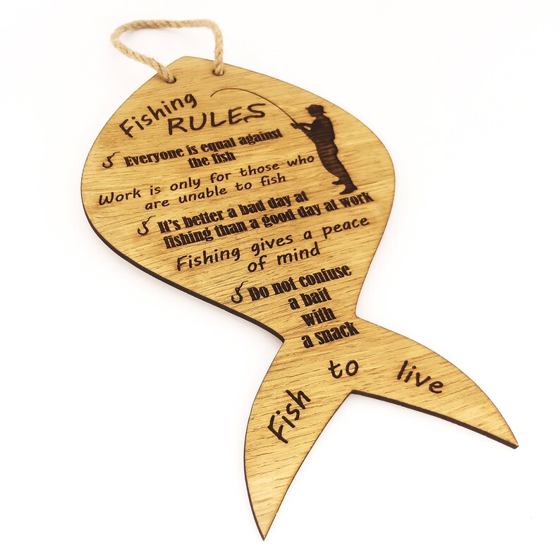 The fishing rules are made of wood. The laser-cut fish-shaped board is engraved with various fishing rules. The rules come with a linen cord for hanging.