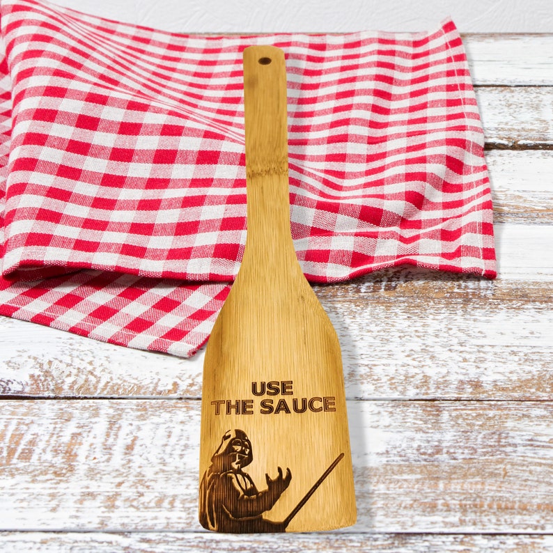 Bamboo spatula is engraved with Darth Vader and the inscription - Use the sauce. The engraved spatula is designed for Star Wars fans.